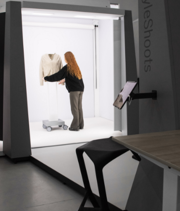 A woman setting clothes in a well lit studio